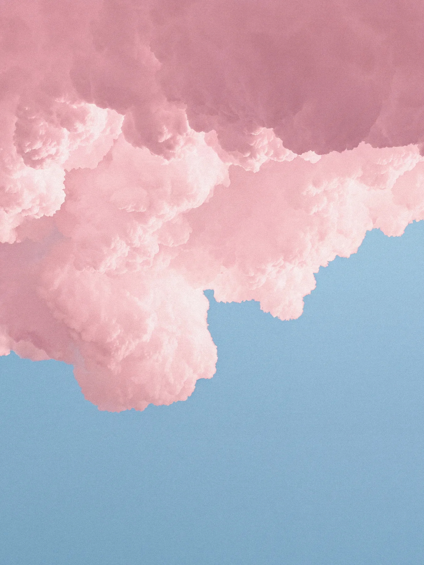 Dreamlike cotton-pink clouds against a powder-blue sky